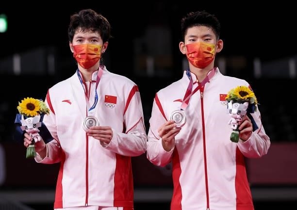 Silver medalists Li Jun Hui and Liu Yu Chen of Team China pose on the podium during the medal ceremony for the Men’s Doubles badminton event on day...