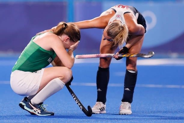 Hannah Martin of Team Great Britain consoles Kathryn Mullan of Team Ireland following the Women's Preliminary Pool A match between Ireland and Great...