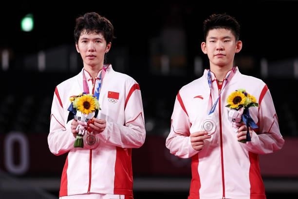 Silver medalists Li Jun Hui and Liu Yu Chen of Team China pose on the podium during the medal ceremony for the Men’s Doubles badminton event on day...