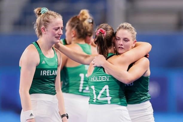 Chloe Watkins embraces team mate Lizzy Holden of Team Ireland following a loss in the Women's Preliminary Pool A match between Ireland and Great...