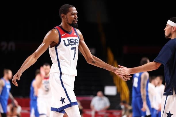 Kevin Durant of Team United States high-fives Devin Booker during the second half of a Men's Basketball Preliminary Round Group A game on day eight...