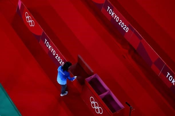 Volunteer disinfects the court after the badminton competition on day eight of the Tokyo 2020 Olympic Games at Musashino Forest Sport Plaza on July...