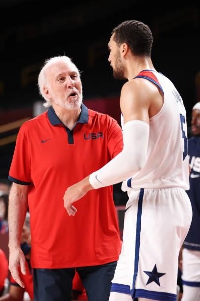 Team United States Head Coach Gregg Popovich speaks with Zachary Lavine during the second half of their Men's Basketball Preliminary Round Group A...