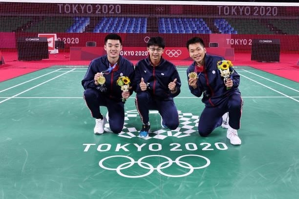 Gold medalists of Men’s Doubles badminton event Lee Yang and Wang Chi-Lin of Team Chinese Taipei pose for photo with their coach Chen Hung-ling on...