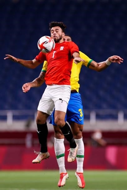 Salah Mohsen of Egypt competes for the ball with Diego Carlos of Brazil in the Men's Quarterfinal match between Brazil and Egypt during the Tokyo...