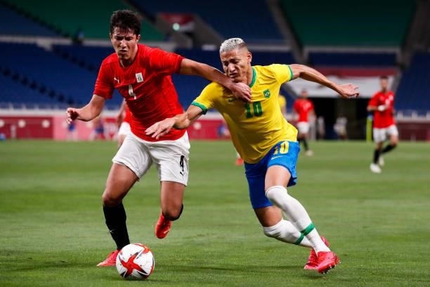Osama Galal of Egypt competes for the ball with Richarlison of Brazil in the Men's Quarterfinal match between Brazil and Egypt during the Tokyo 2020...