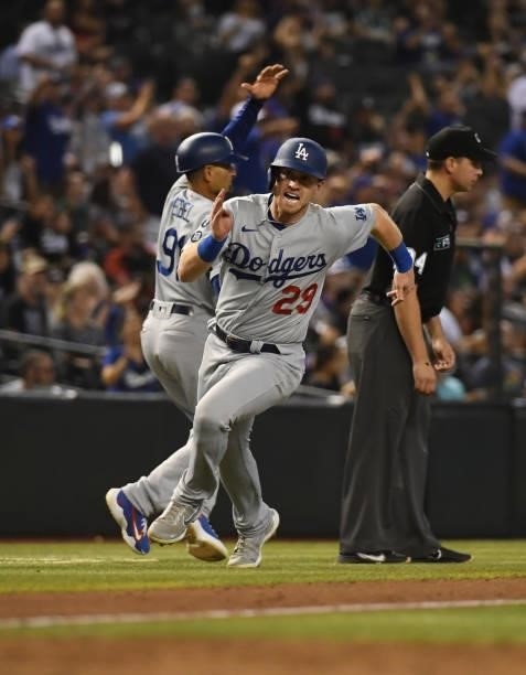 Billy McKinney of the Los Angeles Dodgers scores on a two run triple by Chris Taylor against the Arizona Diamondbacks during the seventh inning at...