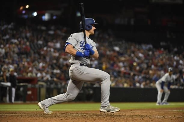 Billy McKinney of the Los Angeles Dodgers follows though on a swing against the Arizona Diamondbacks at Chase Field on July 30, 2021 in Phoenix,...
