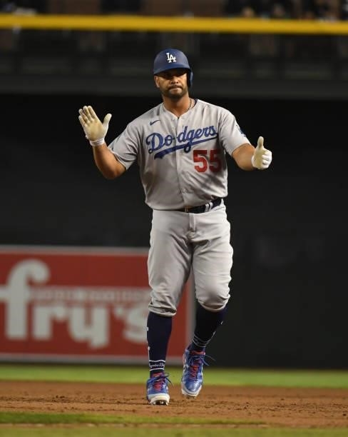 Albert Pujols of the Los Angeles Dodgers reacts after hitting an RBI single against the Arizona Diamondbacks during the eighth inning to tie the game...