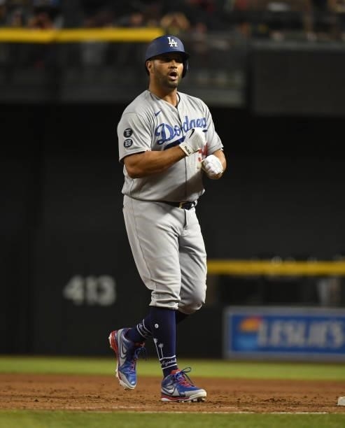 Albert Pujols of the Los Angeles Dodgers reacts after hitting an RBI single against the Arizona Diamondbacks during the eighth inning to tie the game...