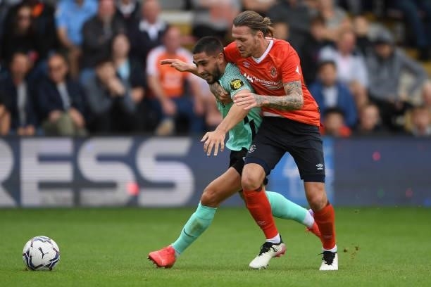 Neal Maupay of Brighton and Hove Albion is challenged by Glen Rea of Luton Town during the Pre-Season Friendly match between Luton Town and Brighton...