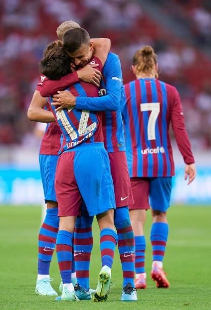 Riqui Puig of Barcelona celebrates after scoring his team's third goal with his teammate Gerard Pique during a pre-season friendly match between VfB...