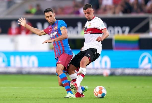 Philipp Forster of Stuttgart competes for the ball with Sergio Busquets of Barcelona during a pre-season friendly match between VfB Stuttgart and FC...