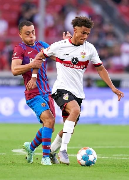 Manuel Polster of Stuttgart competes for the ball with Sergino Dest of Barcelona during a pre-season friendly match between VfB Stuttgart and FC...