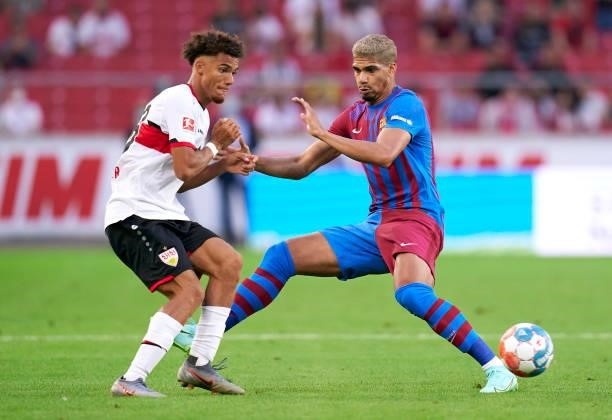 Manuel Polster of Stuttgart competes for the ball with Roland Araujo of Barcelona during a pre-season friendly match between VfB Stuttgart and FC...