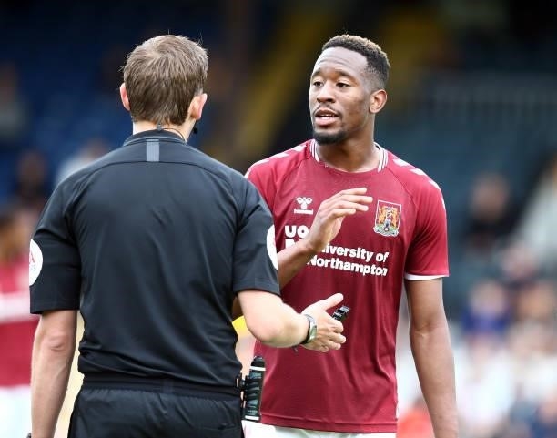 Nicke Kabamba of Northampton Town makes a point to referee Alan Dale during the Pre Season Friendly match between Cambridge United and Northampton...