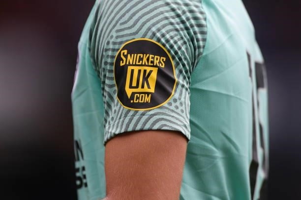 Detailed view of the Snickers UK logo is seen on a Brighton and Hove Albion shirt sleeve during the Pre-Season Friendly match between Luton Town and...