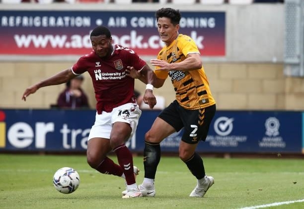 George Williams of Cambridge United contests the ball with Ali Koiki of Northampton Town during the Pre Season Friendly match between Cambridge...