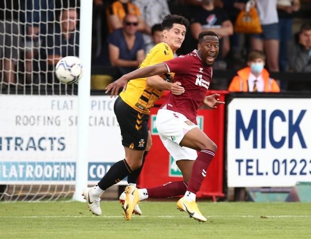 Nicke Kabamba of Northampton Town is held by George Williams of Cambridge United as they contest the ball during the Pre Season Friendly match...