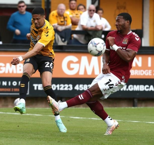 Harvey Knibbs of Cambridge United plays the ball past Ali Koiki of Northampton Town during the Pre Season Friendly match between Cambridge United and...