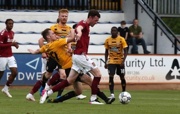 Paul Lewis of Northampton Town moves past the challenge of Adam May of Cambridge United during the Pre Season Friendly match between Cambridge United...