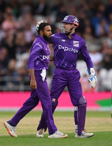 Superchargers bowler Adil Rashid is congratulated by John Simpson after taking the wicket of Laurie Evans during The Hundred match between Northern...