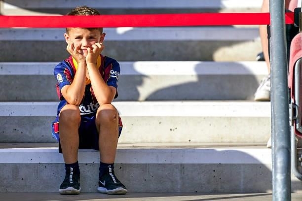 Young of FC Barcelona supporter attends to a pre-season friendly match between VfB Stuttgart and FC Barcelona at Mercedes-Benz Arena on July 31, 2021...