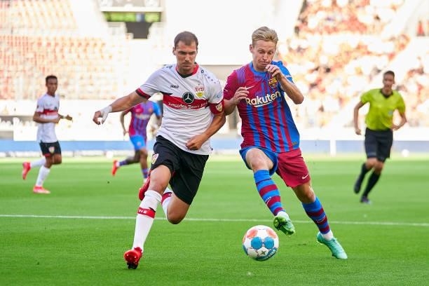 Frenkie De Jong of FC Barcelona competes for the ball against Pascal Stenzel of VfB Stuttgart during a pre-season friendly match between VfB...
