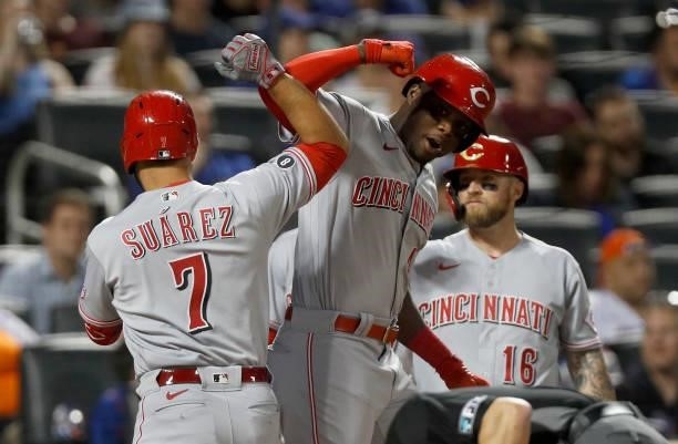 Eugenio Suarez of the Cincinnati Reds celebrates his fourth inning three run home run against the New York Mets with teammate Aristides Aquino at...