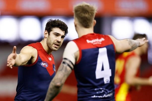 Christian Petracca of the Demons celebrates a Demons goal with James Harmes of the Demons during the round 20 AFL match between Gold Coast Suns and...