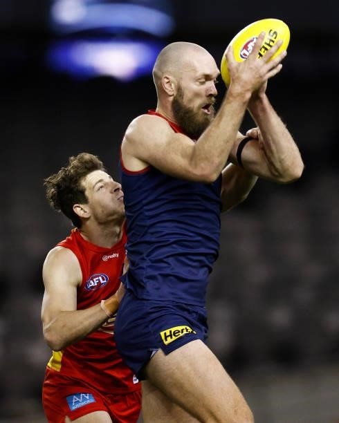 Max Gawn of the Demons marks the ball against Chris Burgess of the Suns during the round 20 AFL match between Gold Coast Suns and Melbourne Demons at...