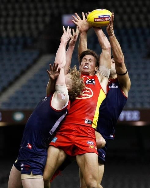 David Swallow of the Suns attempts to mark the ball against Clayton Oliver of the Demons and Christian Petracca of the Demons during the round 20 AFL...