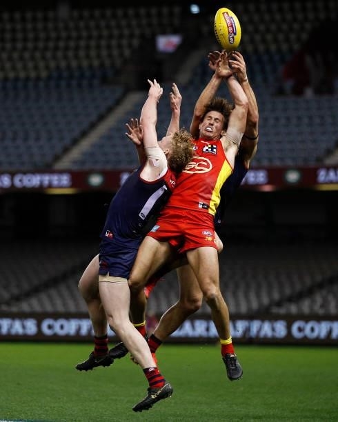 David Swallow of the Suns attempts to mark the ball against Clayton Oliver of the Demons and Christian Petracca of the Demons during the round 20 AFL...