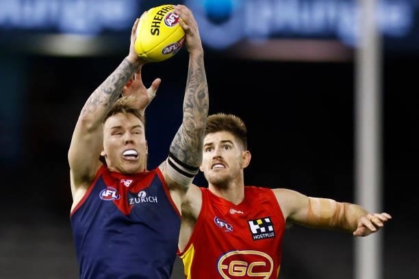 James Harmes of the Demons marks the ball against Zac Smith of the Suns during the round 20 AFL match between Gold Coast Suns and Melbourne Demons at...