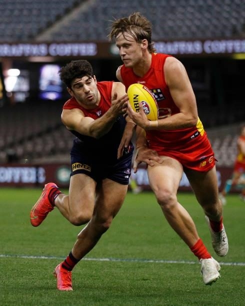 Noah Anderson of the Suns and Christian Petracca of the Demons contest the ball during the round 20 AFL match between Gold Coast Suns and Melbourne...