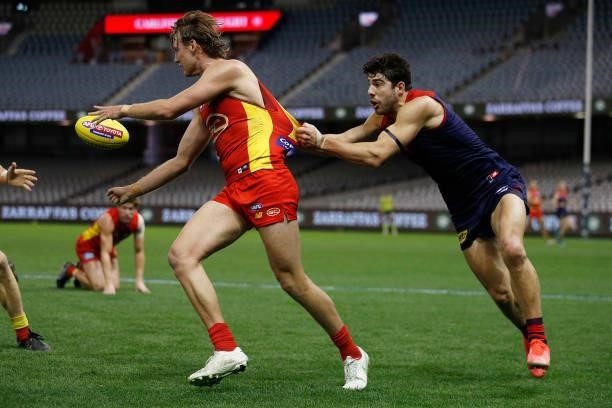 Noah Anderson of the Suns is tackled by Christian Petracca of the Demons during the round 20 AFL match between Gold Coast Suns and Melbourne Demons...