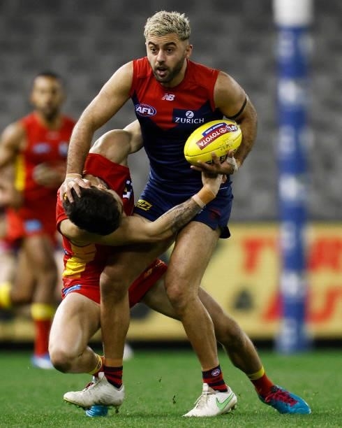 Christian Salem of the Demons is tackled by Alex Sexton of the Suns during the round 20 AFL match between Gold Coast Suns and Melbourne Demons at...