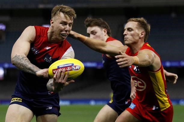 James Harmes of the Demons handballs during the round 20 AFL match between Gold Coast Suns and Melbourne Demons at Marvel Stadium on August 01, 2021...