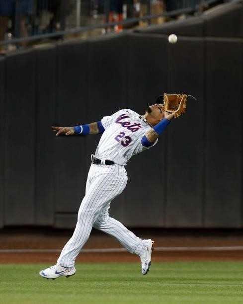Javier Baez of the New York Mets makes a catch to end the ninth inning against the Cincinnati Reds at Citi Field on July 31, 2021 in New York City....