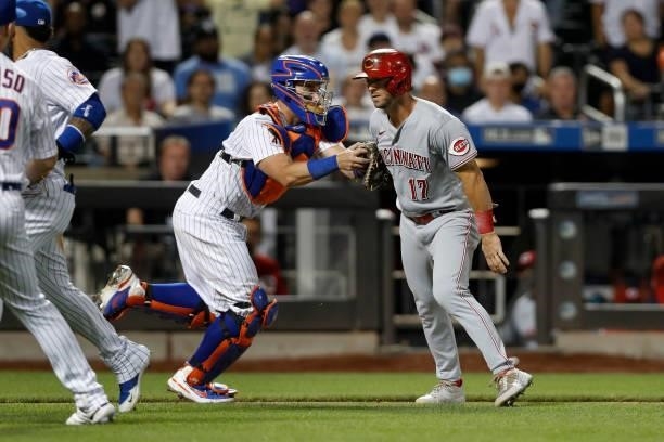 Kyle Farmer of the Cincinnati Reds is tagged out by James McCann of the New York Mets to end the eighth inning at Citi Field on July 31, 2021 in New...