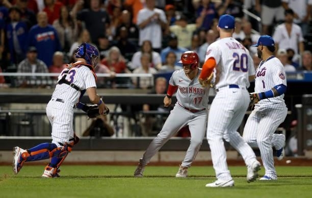 Kyle Farmer of the Cincinnati Reds is tagged out by James McCann of the New York Mets to end the eighth inning at Citi Field on July 31, 2021 in New...