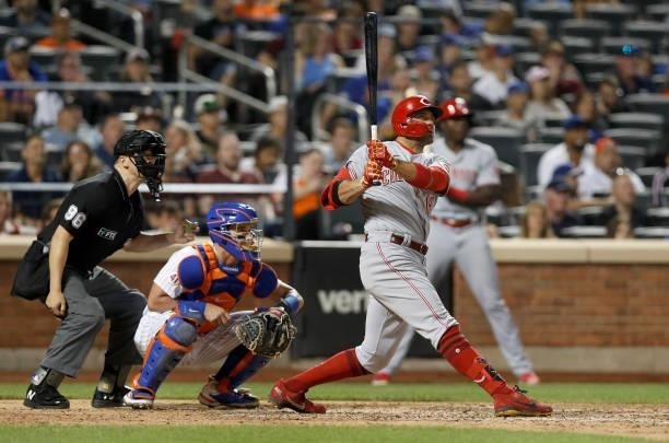 Joey Votto of the Cincinnati Reds singles in the eighth inning against the New York Mets at Citi Field on July 31, 2021 in New York City. The Mets...