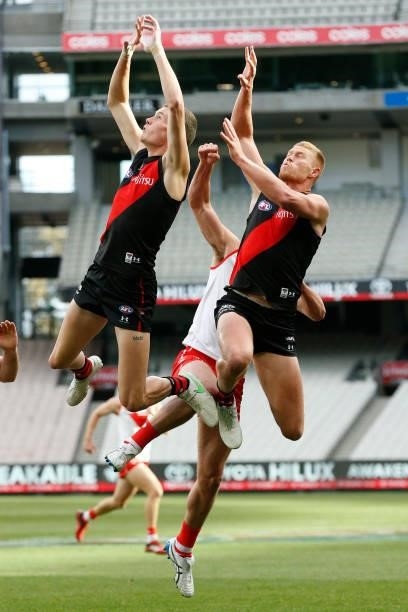 Nikolas Cox and Peter Wright of the Bombers attempts to mark the ball during the round 20 AFL match between Essendon Bombers and Sydney Swans at...