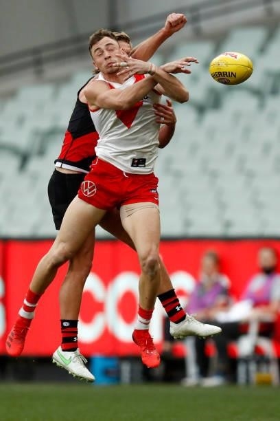 Will Hayward of the Swans attempts to mark the ball as Darcy Parish of the Bombers spoils during the round 20 AFL match between Essendon Bombers and...