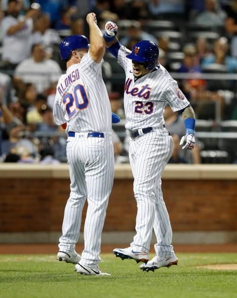 Javier Baez of the New York Mets celebrates his sixth inning two run home run against the Cincinnati Reds with teammate Pete Alonso at Citi Field on...