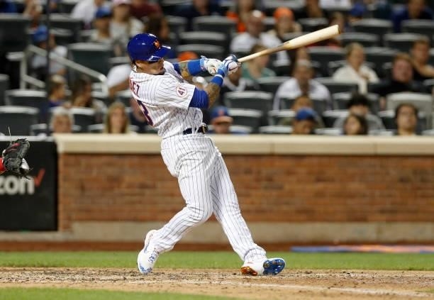 Javier Baez of the New York Mets follows through on his sixth inning two run home run against the Cincinnati Reds at Citi Field on July 31, 2021 in...