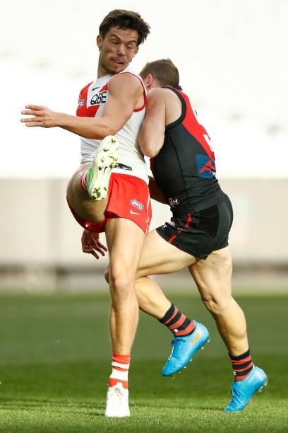 Devon Smith of the Bombers bumps Oliver Florent of the Swans during the round 20 AFL match between Essendon Bombers and Sydney Swans at Melbourne...