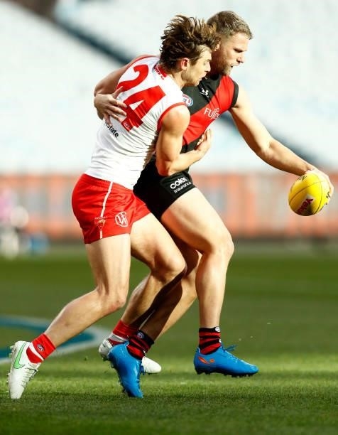 Dane Rampe of the Swans tackles Jake Stringer of the Bombers during the round 20 AFL match between Essendon Bombers and Sydney Swans at Melbourne...