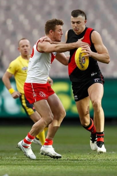 Sam Draper of the Bombers is tackled by Luke Parker of the Swans during the round 20 AFL match between Essendon Bombers and Sydney Swans at Melbourne...