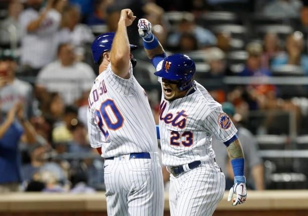 Javier Baez of the New York Mets celebrates his sixth inning two run home run against the Cincinnati Reds with teammate Pete Alonso at Citi Field on...